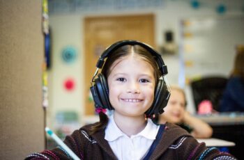 Girl in classroom wearing headphones